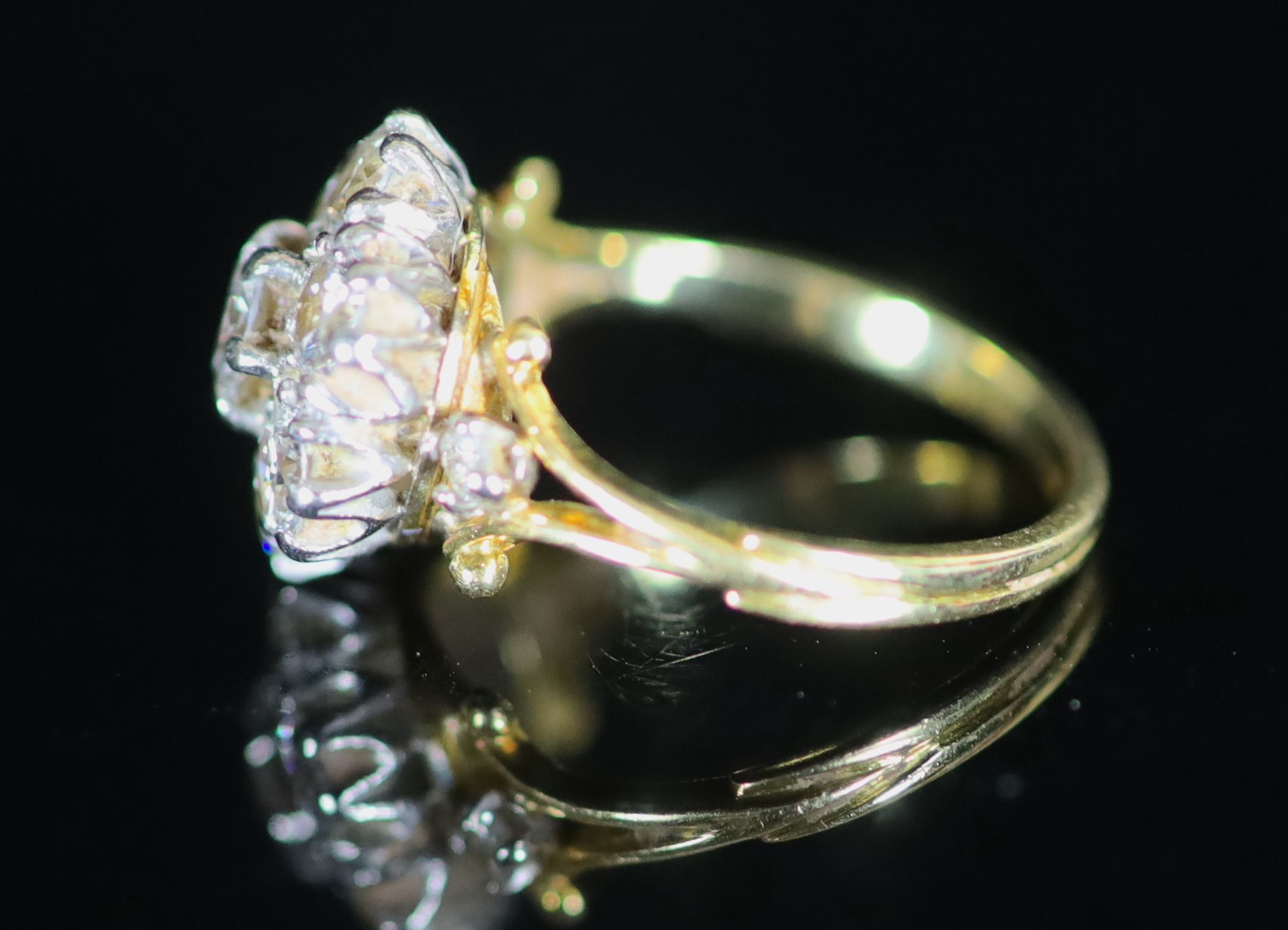 A mid 20th century gold and seven stone diamond cluster ring